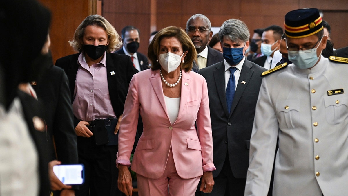 House Speaker Nancy Pelosi walks in Kuala Lumpur's parliament house