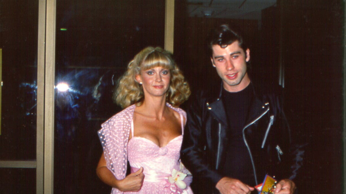 Olivia Newton-John and John Travolta attend the premiere of "Grease."