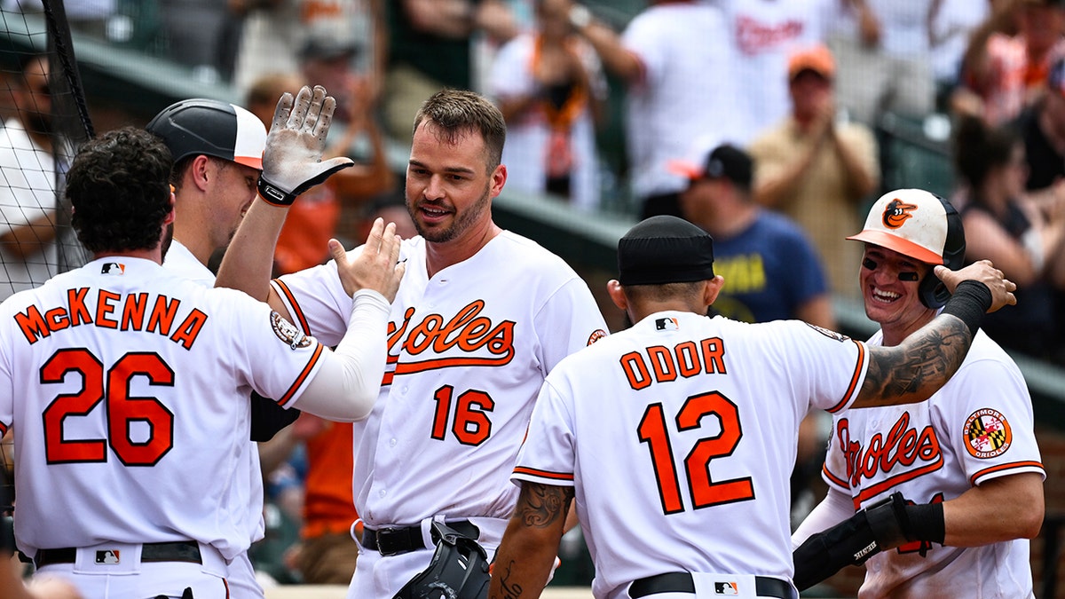 Trey Mancini greeted by Orioles players