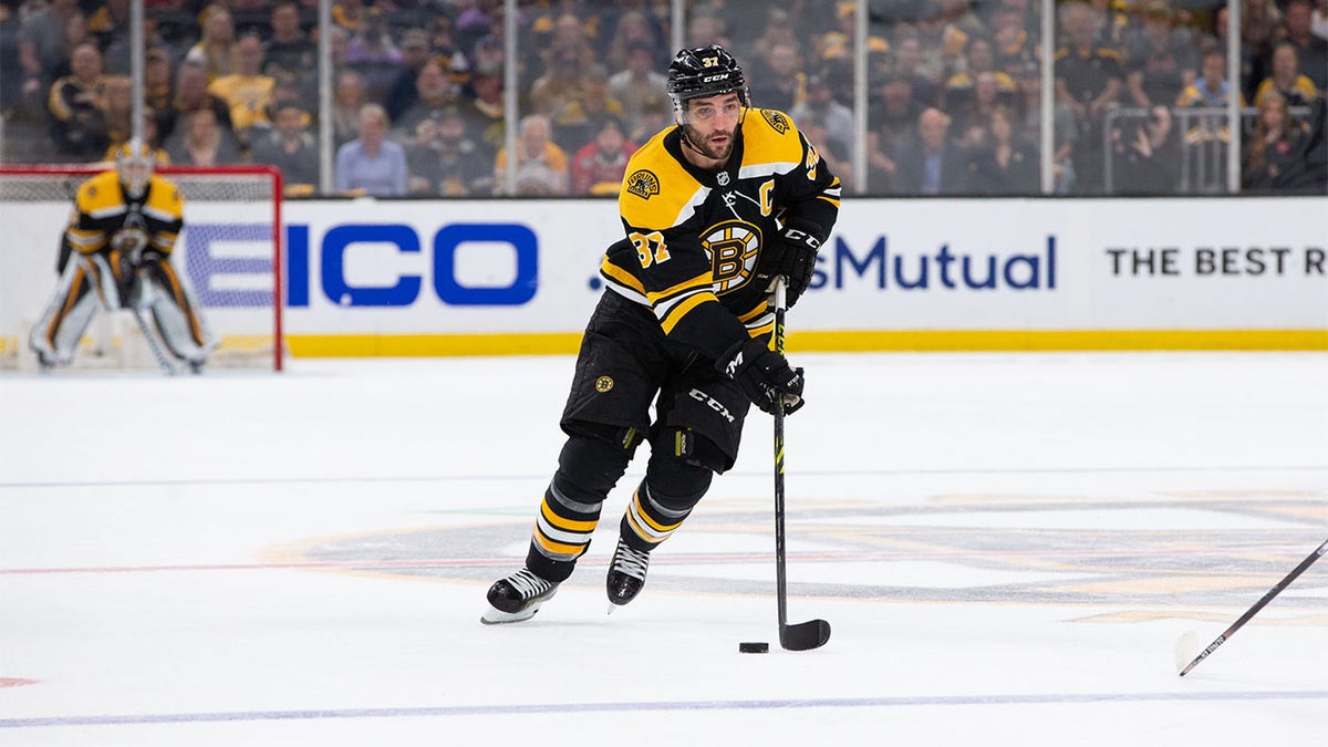 Patrice Bergeron skates with the puck
