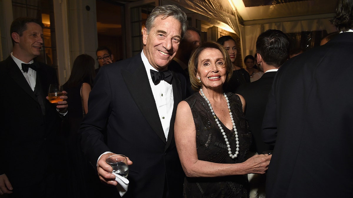 Paul Pelosi (L) and Nancy Pelosi in formal attire at a party