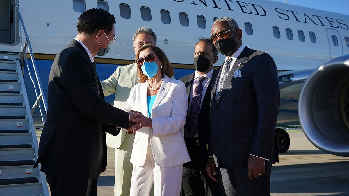 Taiwan's Foreign Minister Joseph Wu, left, speaks with U.S. House Speaker Nancy Pelosi