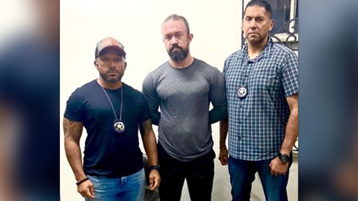 Marshals flank RJ McLeod after his arrest in El Salvador