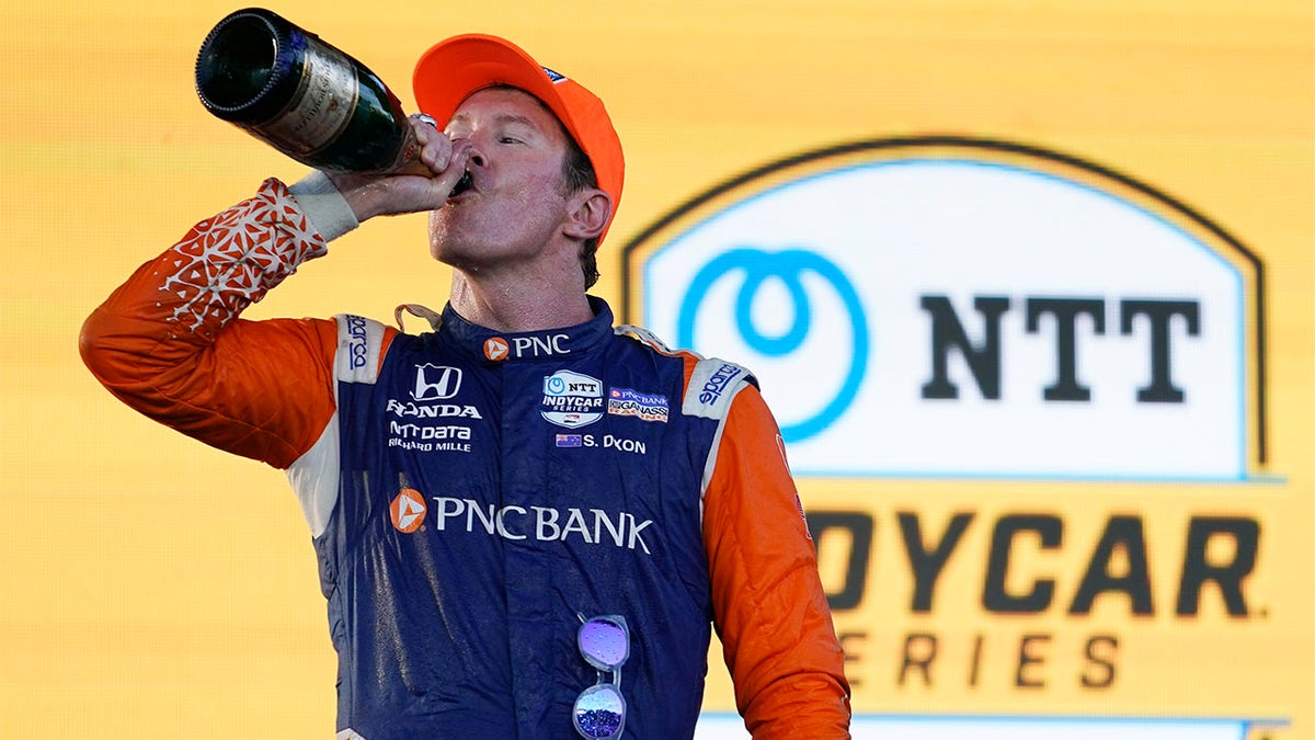 Scott Dixon drinks champagne