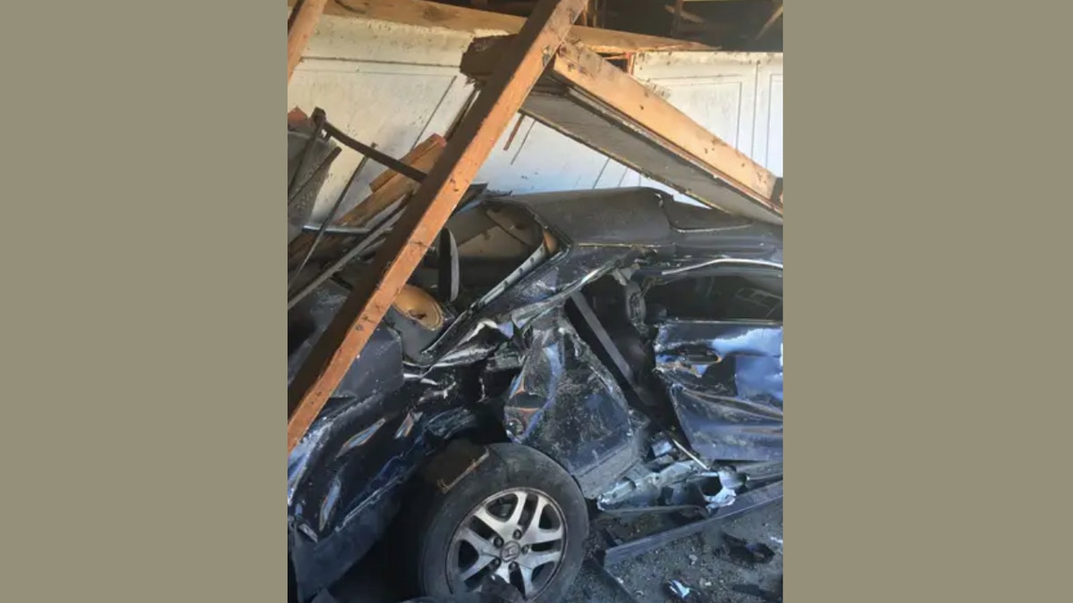 A photo of a heavily damage car that slammed into a California home