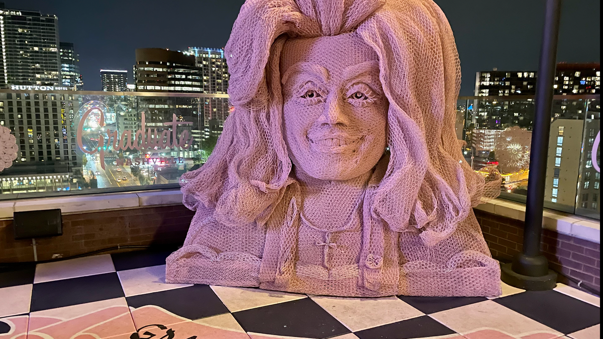White Limozeen is a new Dolly Parton-themed rooftop bar at The Graduate hotel in Nashville. The decor includes a 10-foot-tall bust of Parton crafted from chicken wire by Tennessee artist Ricky Pittman.