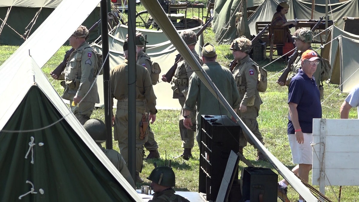 Solider stand at attention under a tent at D-Day reenactment in Ohio