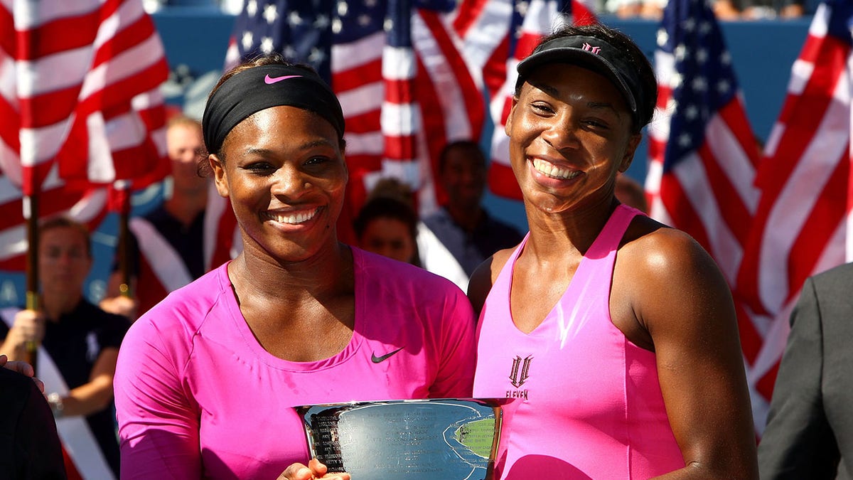Serena and Venus Williams with US Open doubles trophy