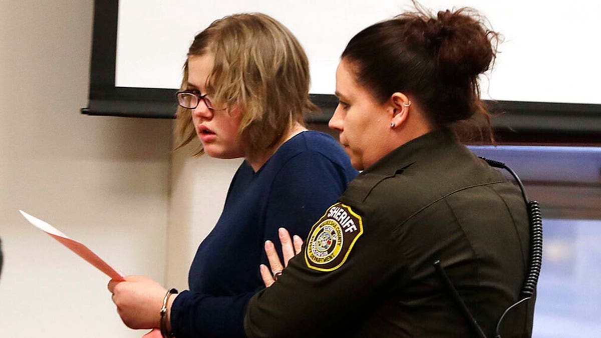 Wisconsin woman charged in 2014 Slender Man stabbing being led out of court.