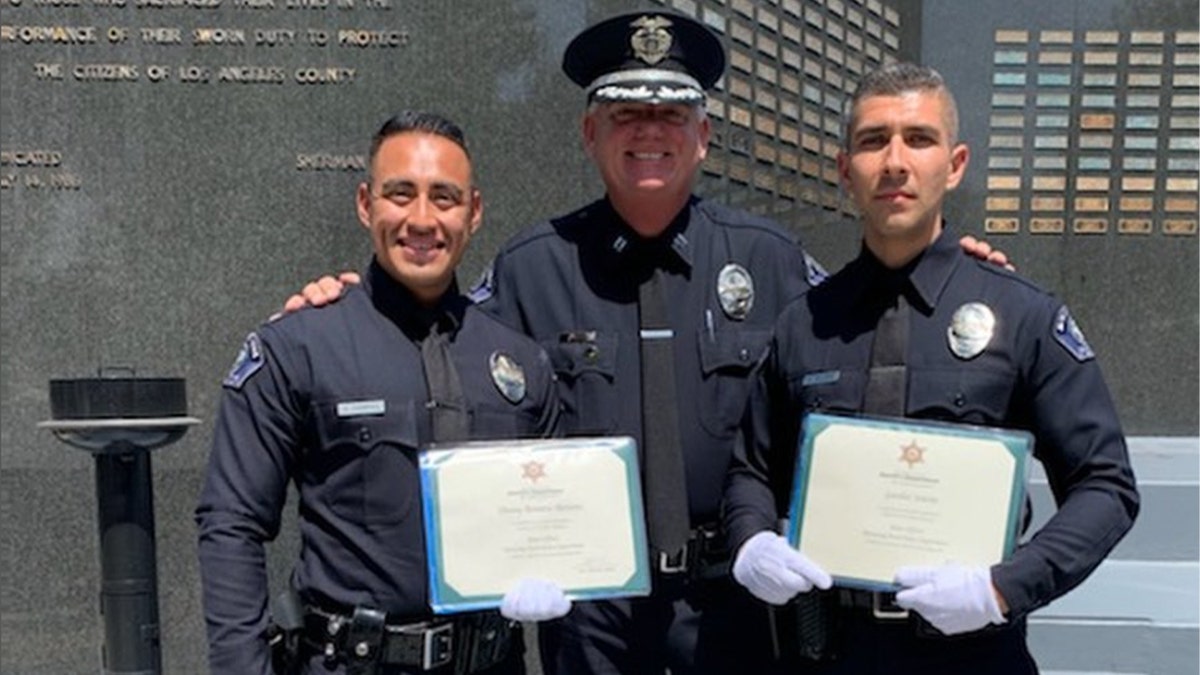 Monterey Park Police Officer Gardiel Solorio smiles in a photo op with two other officers