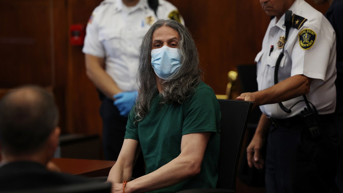 Victor Pena in court wearing a coronavirus mask and green T-shirt