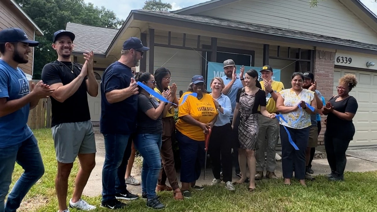 People celebrating as Ms. Claudette is welcomed home