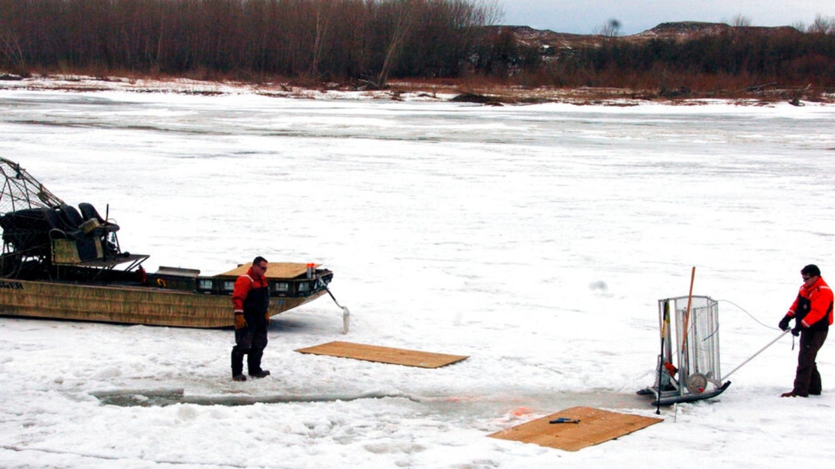 Workers on ice on the Yellowstone River