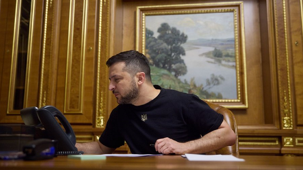 Volodymyr Zelenskyy wearing black shirt in the Ukraine presidential office taking Biden's phone call