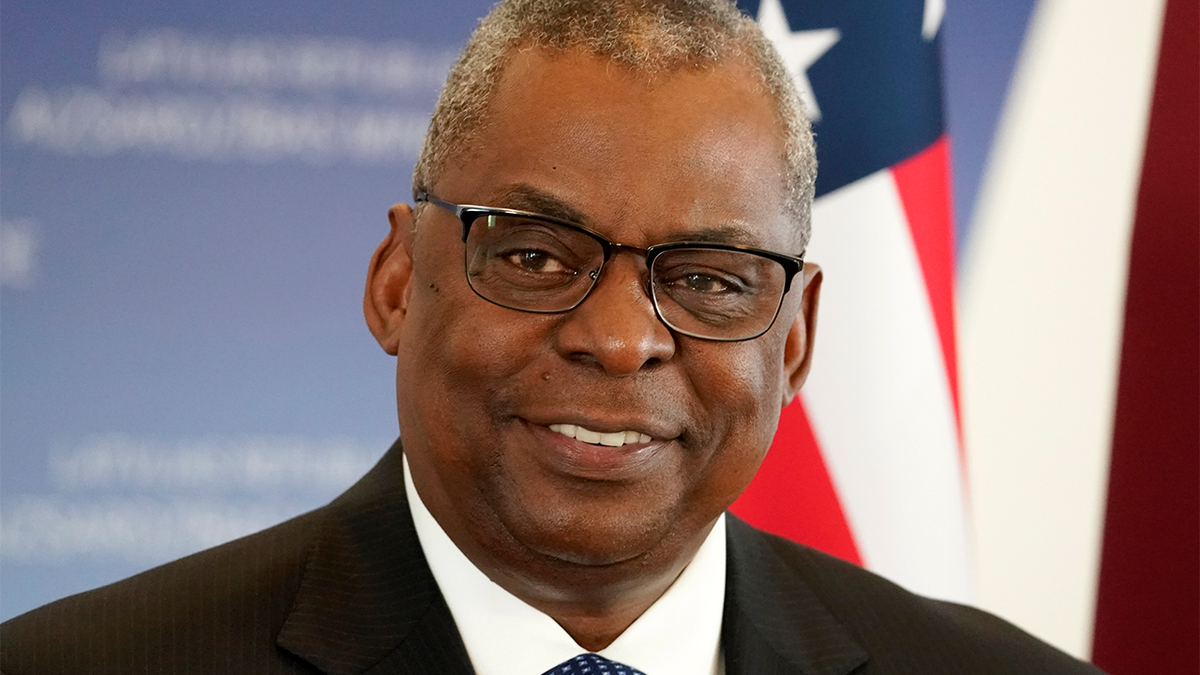 U.S. Secretary of Defense Lloyd Austin smiles during the press conference