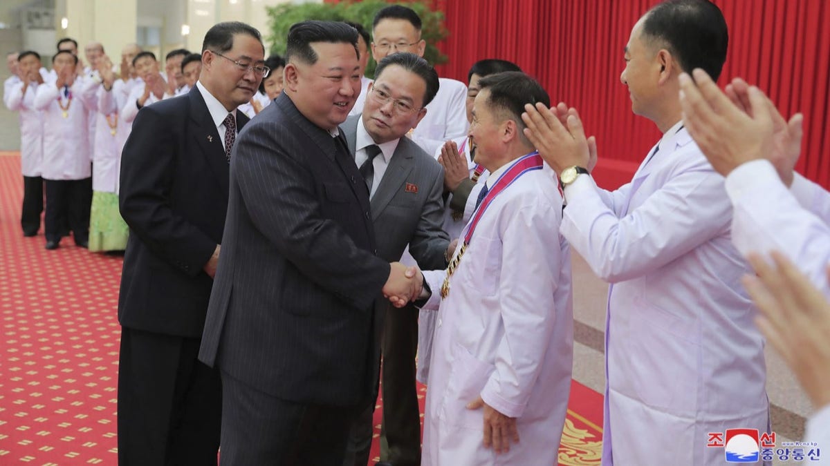 Kim Jong Un shaking hands at an event