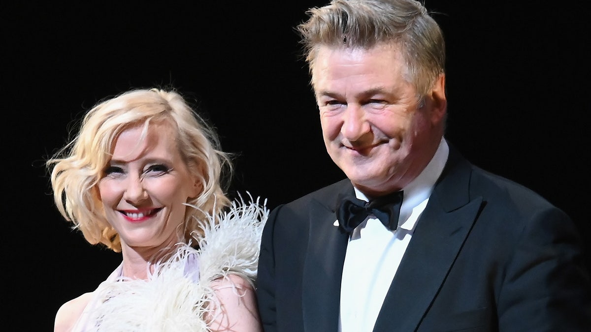 Alec Baldwin in a suit and Anne Heche in a feather dress on Broadway