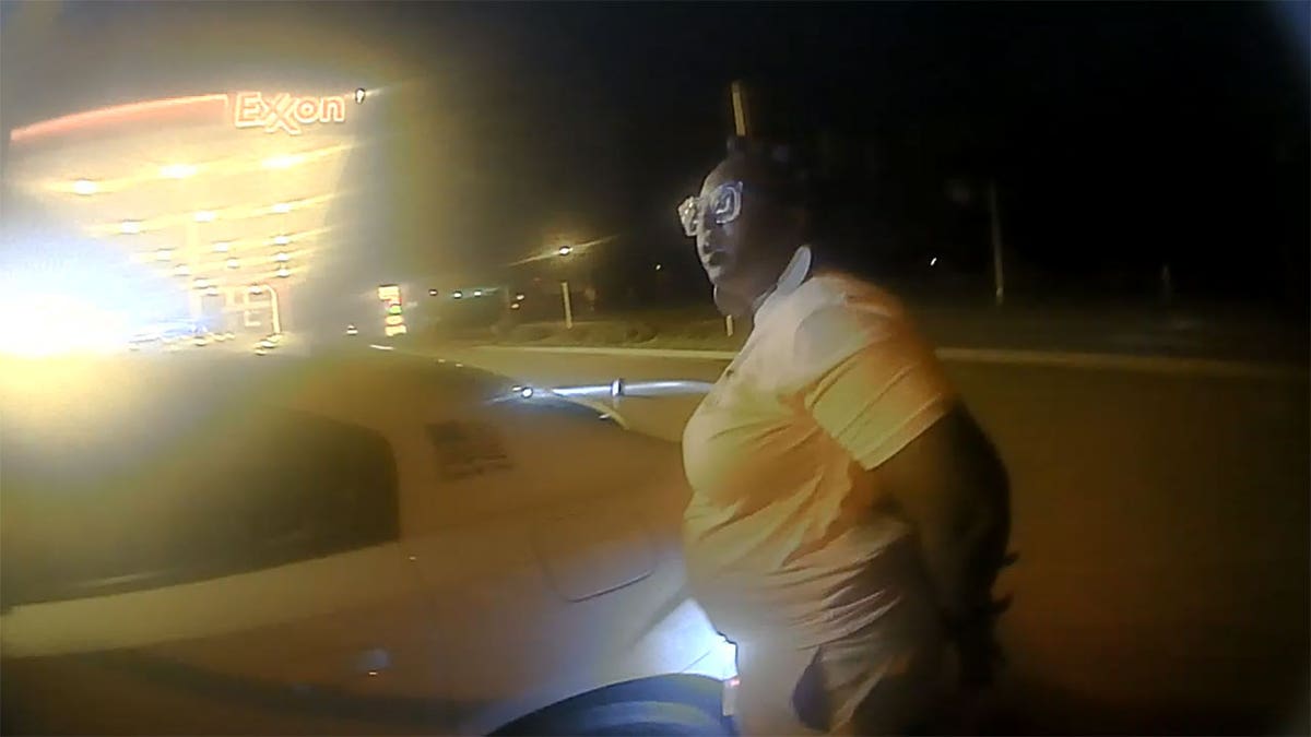 Ebony Washington in handcuffs outside sheriff vehicle