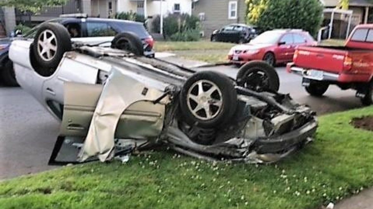 Vehicle sits upside with crushed ceiling