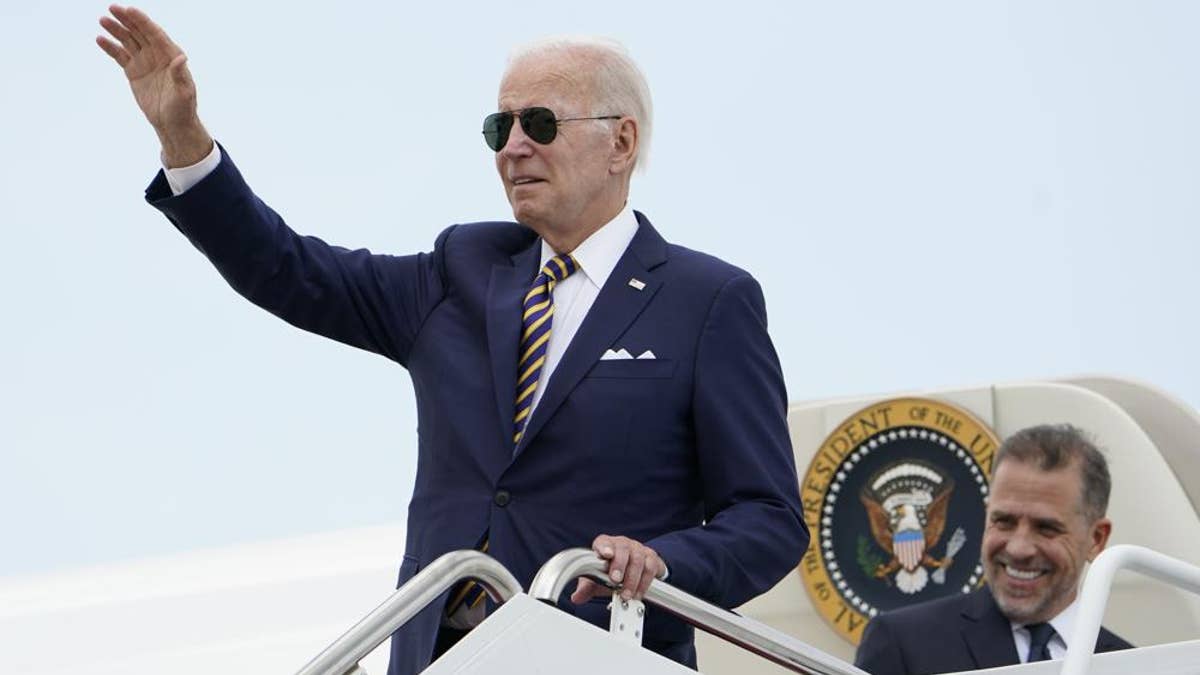 President Biden waves to reporters