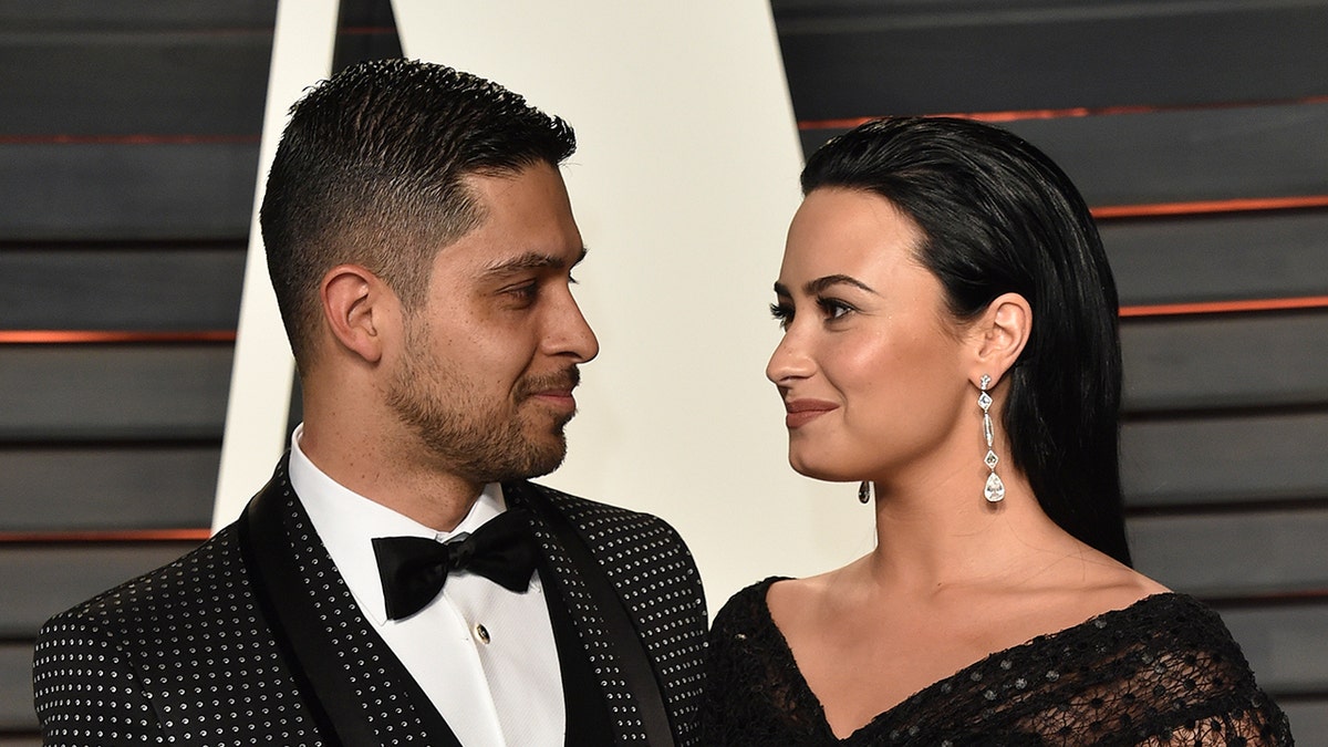 Demi Lovato and Wilmer Valderrama looking at each other