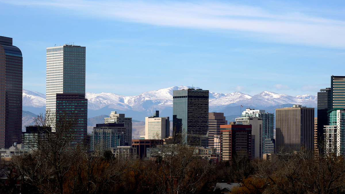 Photo showing Denver skyline in front of mountains