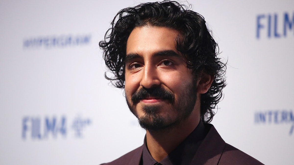 Dev Patel poses for a photo