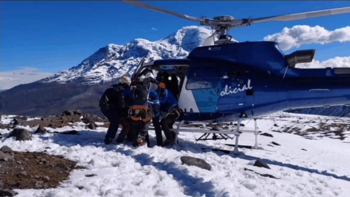 Rescuers helping victim into helicopter