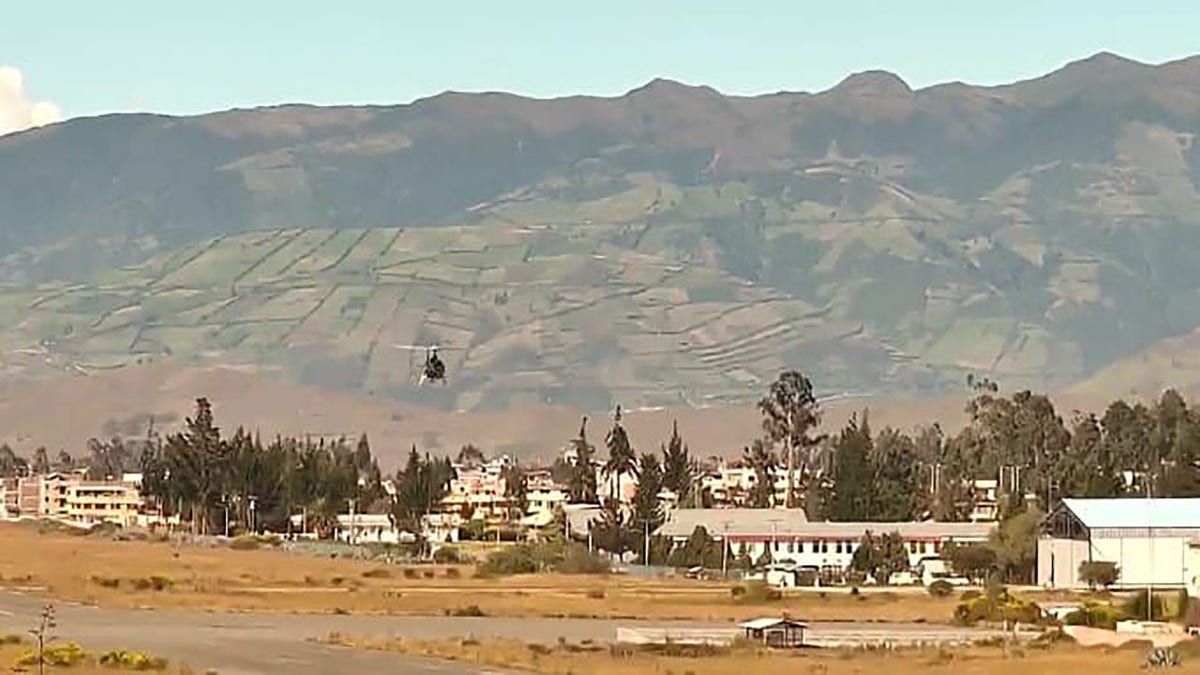 Helicopter flying toward mountain