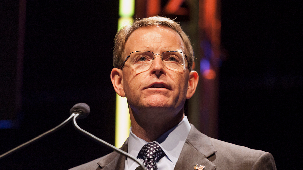 Photo of Family Research Council president Tony Perkins speaking at a microphone while wearing a suit at an event