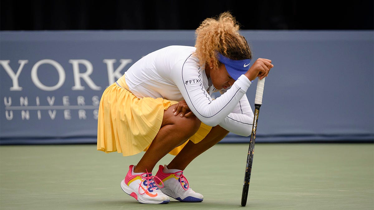 Naomi Osaka crouches down