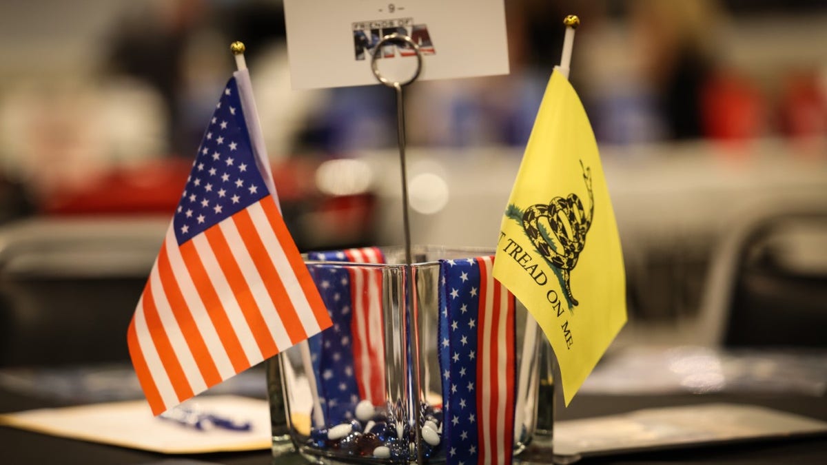 Photo showing American and Gadsen flags sitting on table at Friends of NRA event 