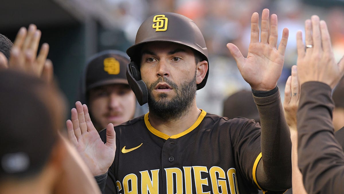 Eric Hosmer high fiving teammates in dugout