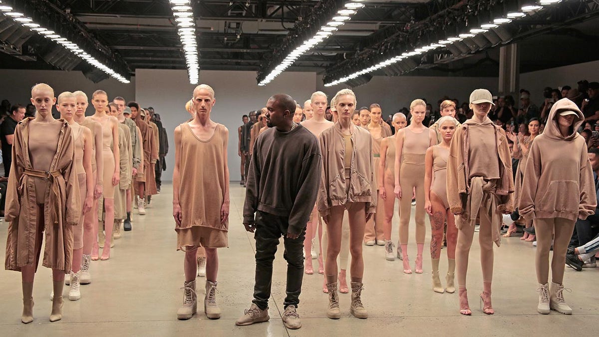 Kanye West with models wearing his collection