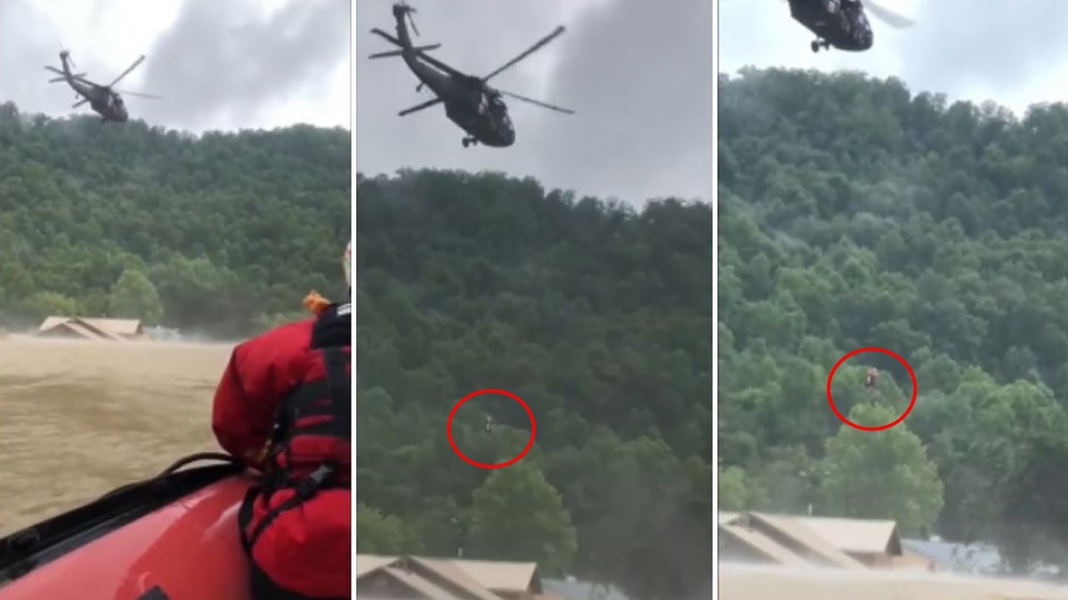 Helicopter hoists a person to safety from a home as floodwaters swirl