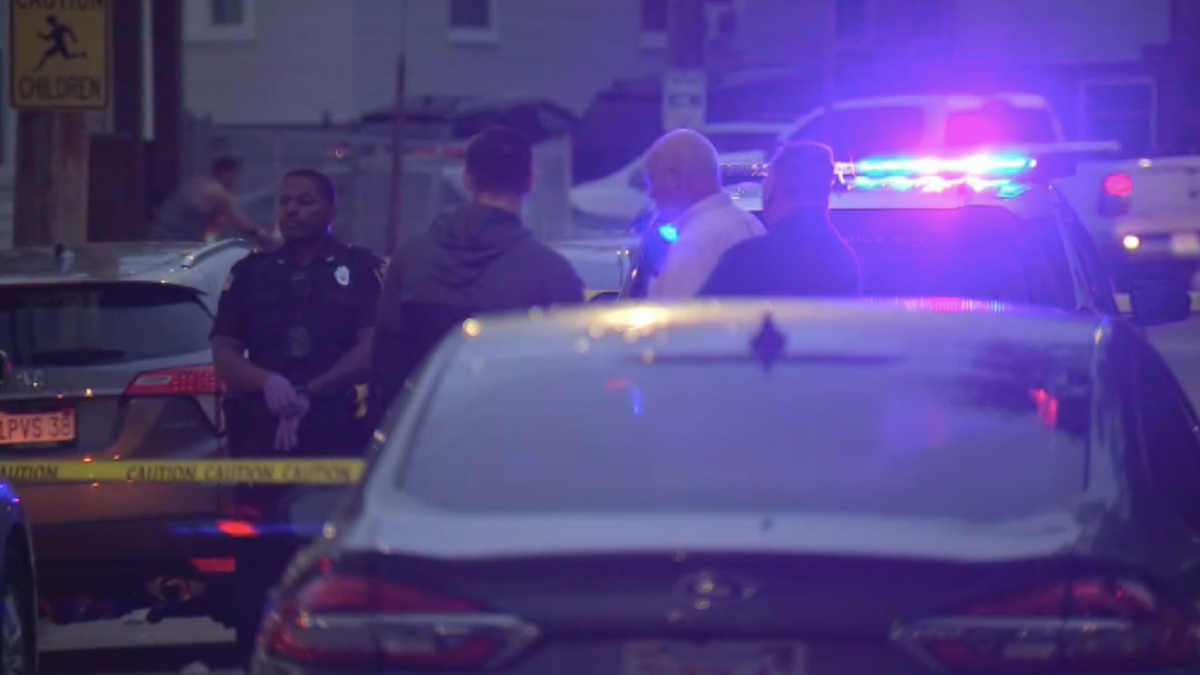 Police cars and investigators outside of crime scene