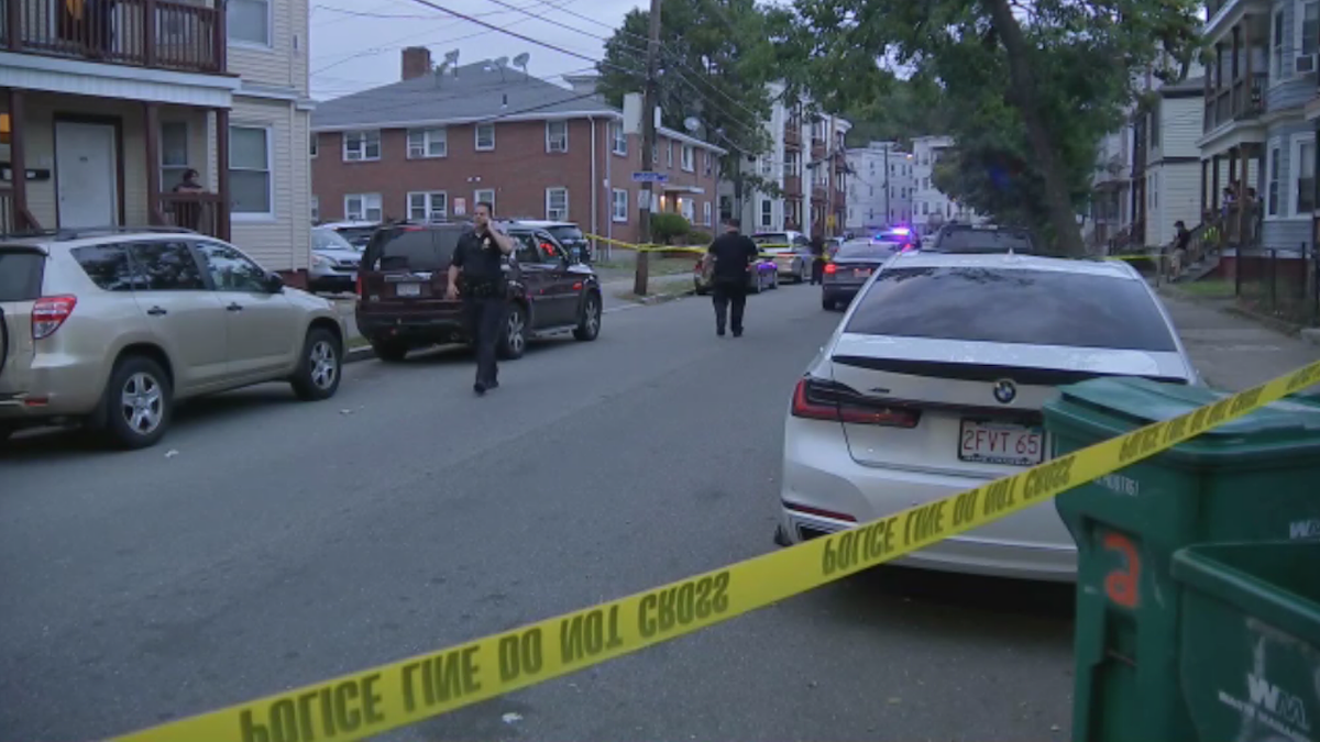 Authorities outside home with yellow caution tape