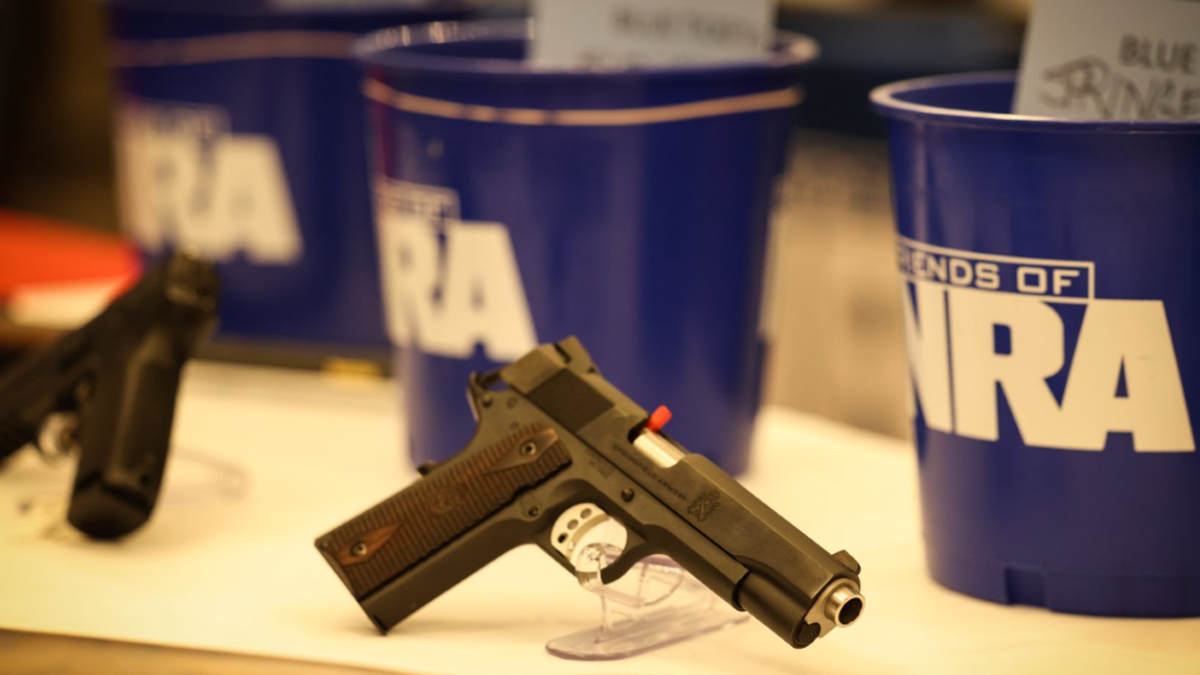 Photo showing firearm sitting on table at NRA affiliated event