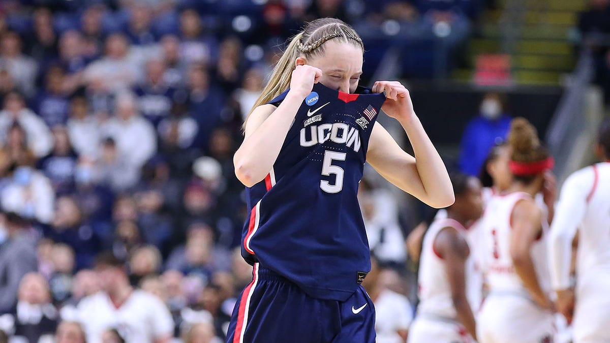 Paige Bueckers covers face with jersey