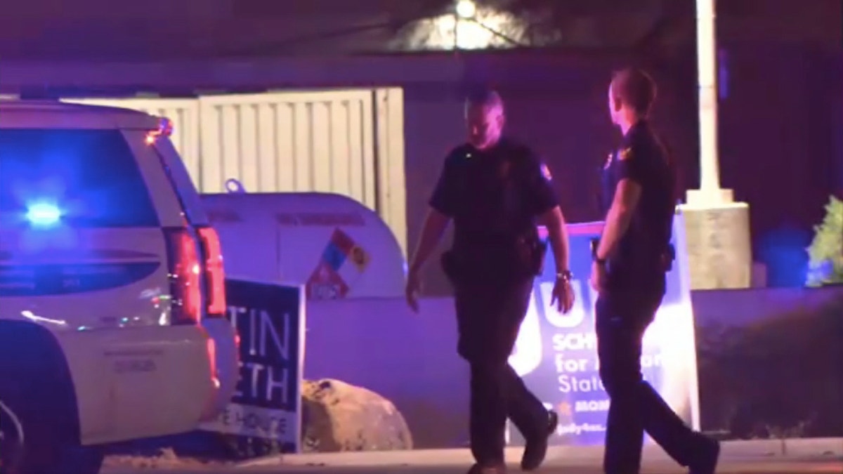 Two officers walking near crime scene in Phoenix
