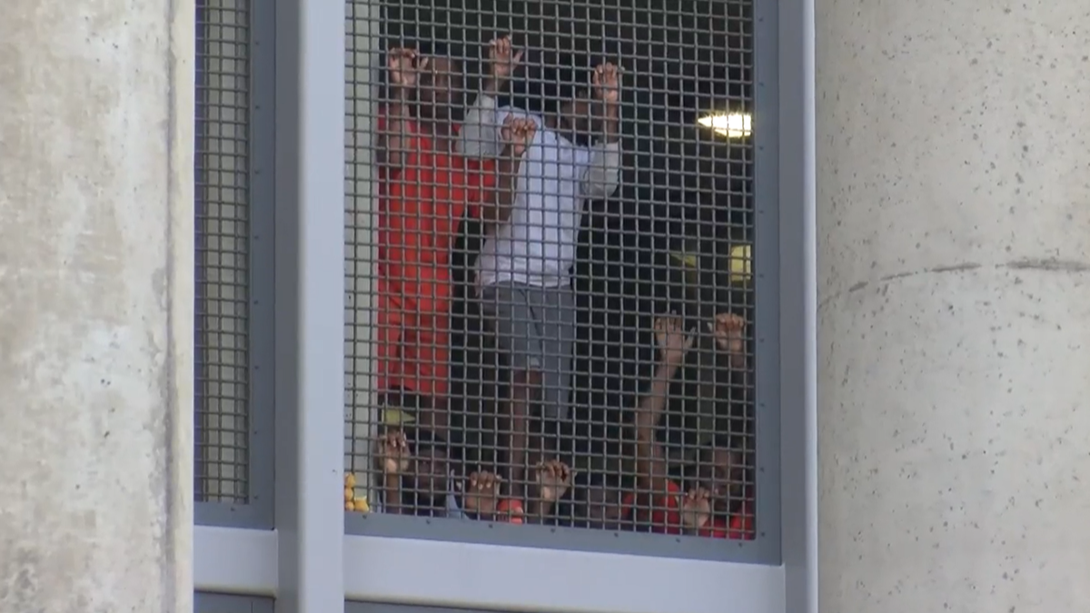 Prisoners seen from window during protest