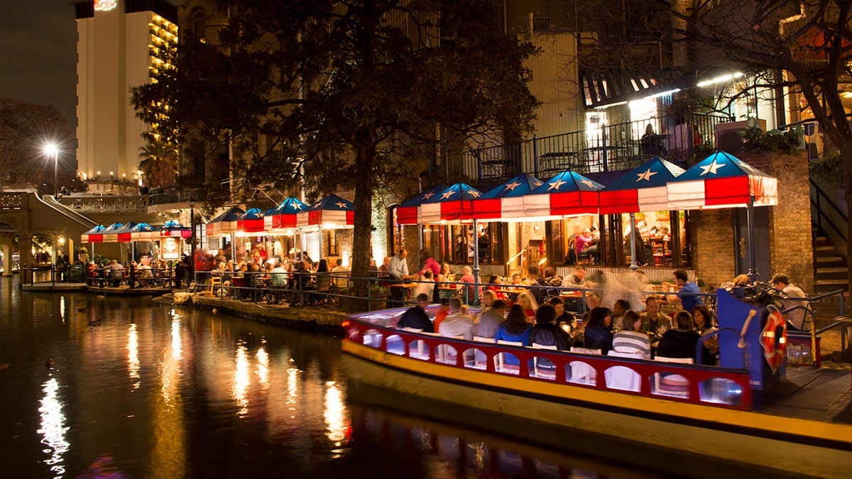 People dining at a restaurant on the water.