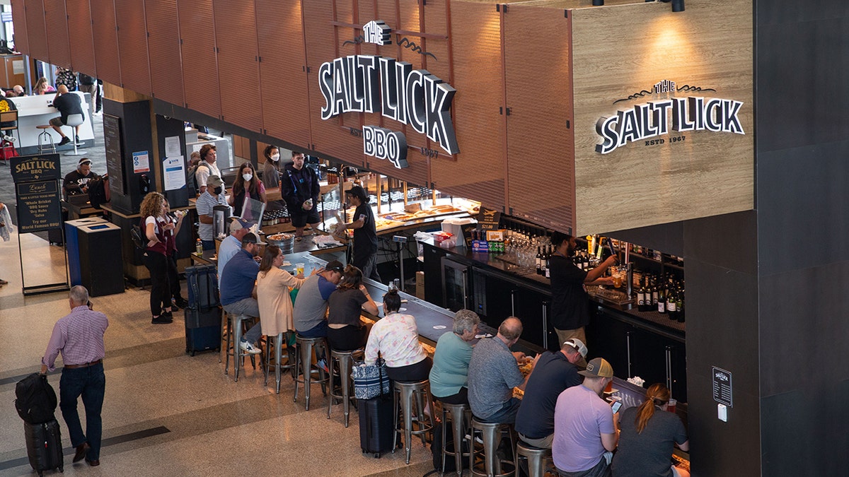 People lining up at the bar inside The Salt Lick BBQ & Wine Cellars restaurant in Austin, Texas