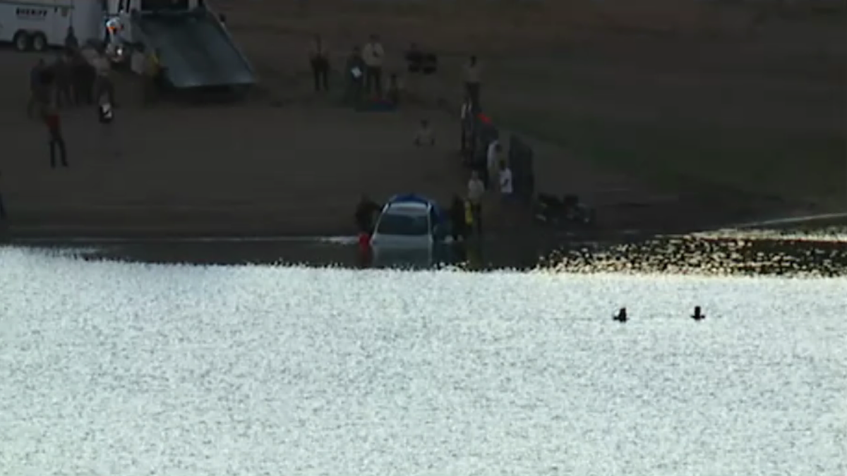 Car being removed from lake