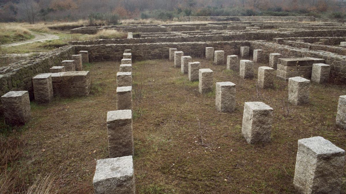 Pillars emerge in a stone square, remains of a Roman military camp in Northwest Spain