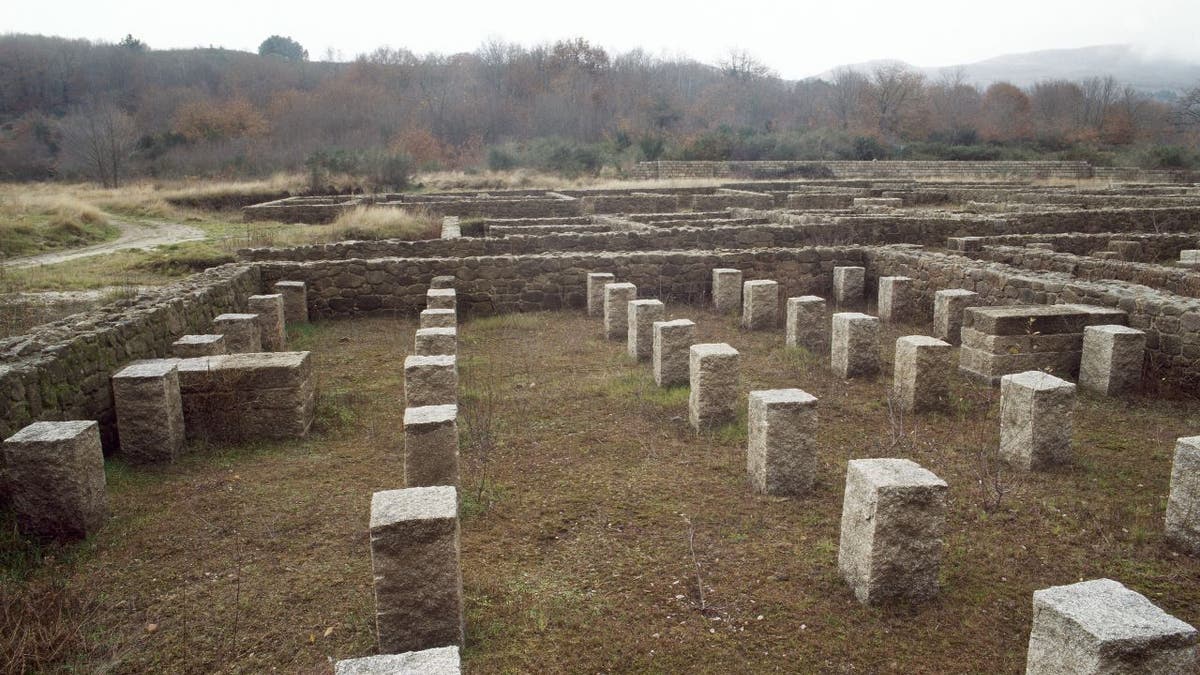 Pillars emerge in a stone square, remains of a Roman military camp in Northwest Spain