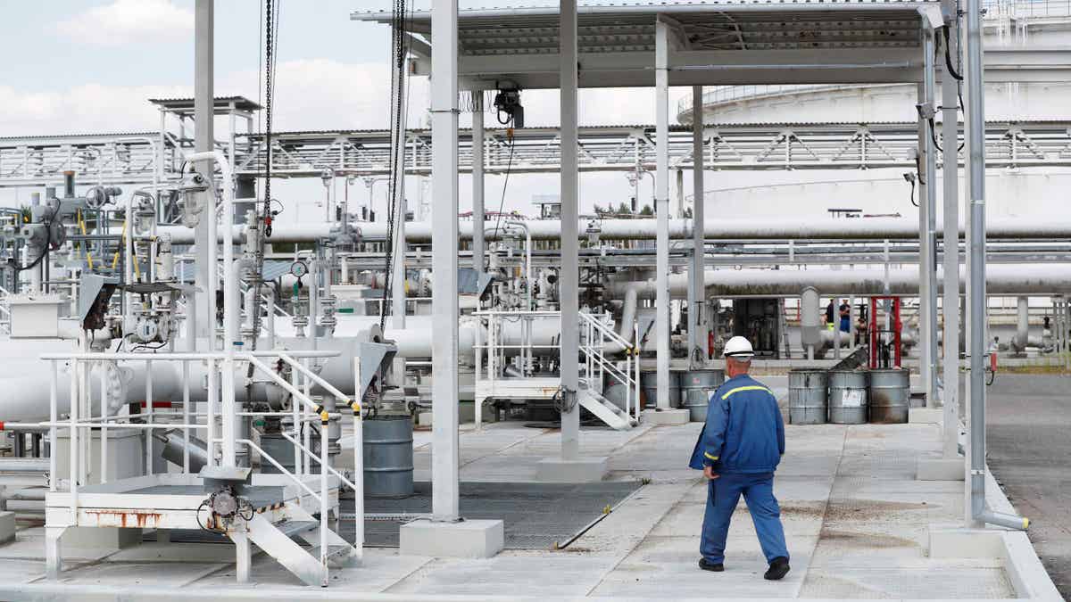 Man walks by pipeline