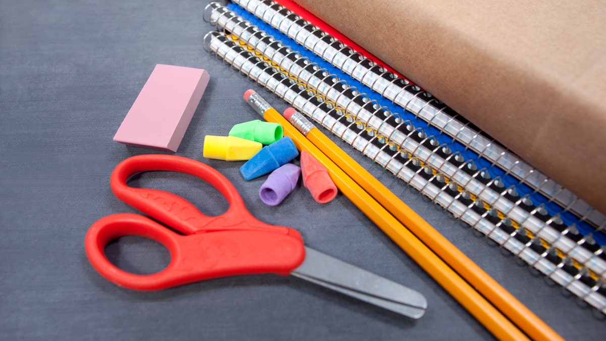 Scissors, eraser, notebooks, and pencils