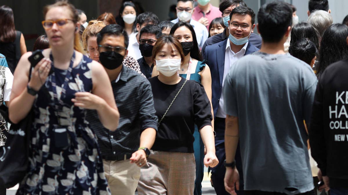 People walking in business district in Singapore