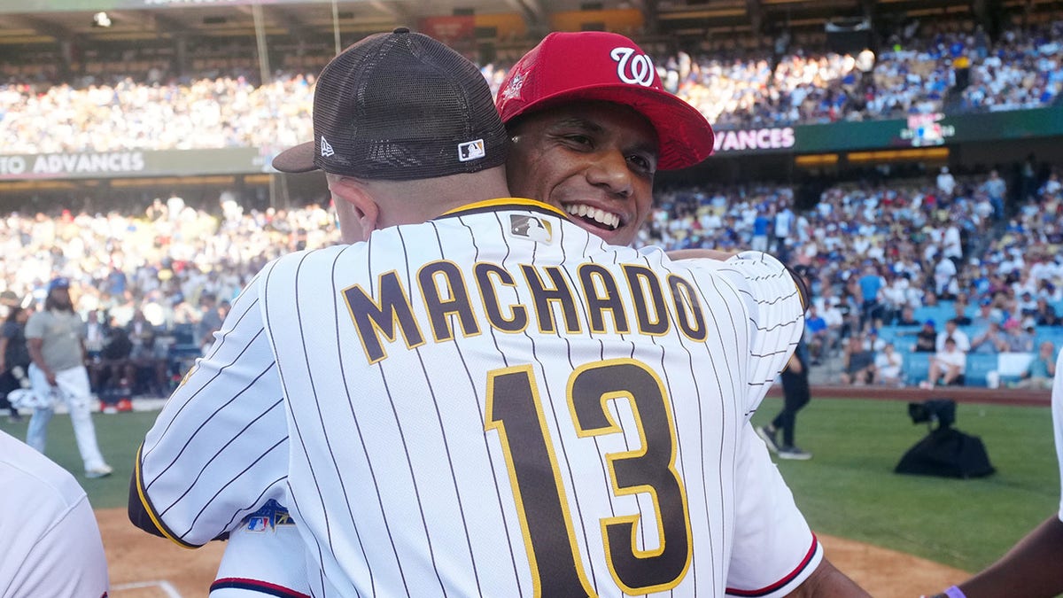 Juan Soto hugs Manny Machado after winning Home Run Derby